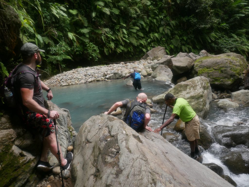Hikers making their way up the White River in Dominica