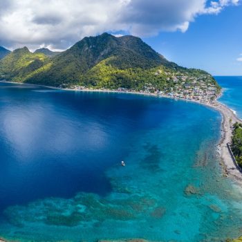 Scotts Head, Dominica, West Indies. On right  side is Caribbean Sea, on left side - Atlantic Ocean. November 2019. Drone photo, stitched panorama.